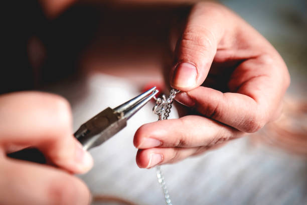 Young woman crafting jewelry from scratch.